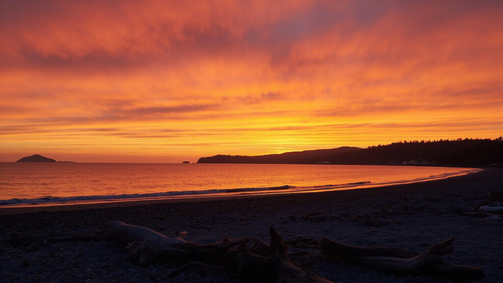 Dramatic crimson and gold sunset over the beach and bay at White Rock BC