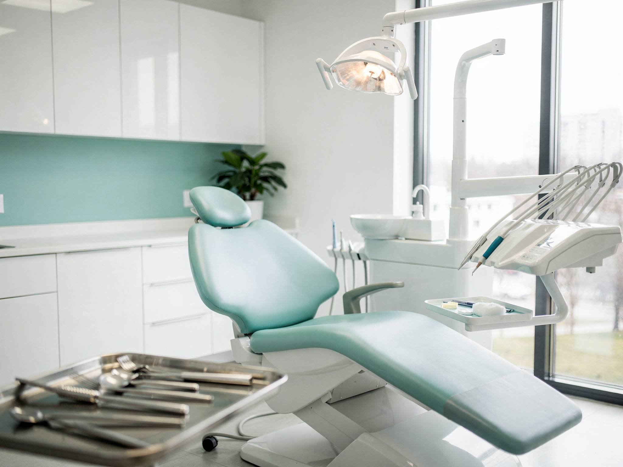 Bright, modern dental treatment room with teal accents