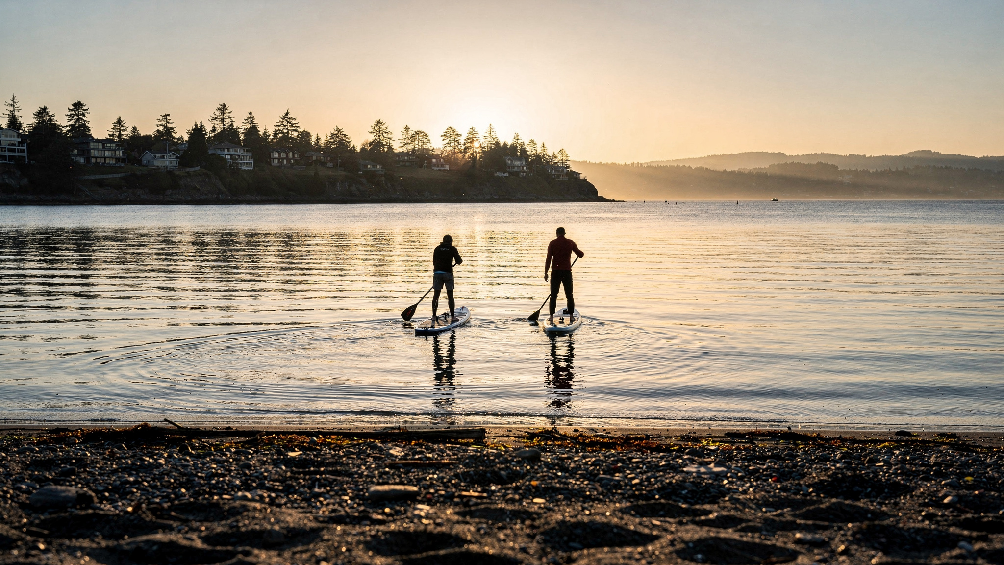 wr paddle hero v2 Paddleboarding and Kayaking Spots Near White Rock BC Two paddleboarders silhouetted from behind on a calm bay near White Rock BC
